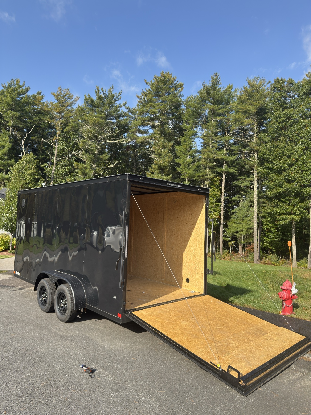 Blackrock's black enclosed dual-axle wash trailer with the rear ramp down